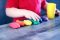 A young child with rainbow-colored modeling clay and stacking cups on a table indoors.